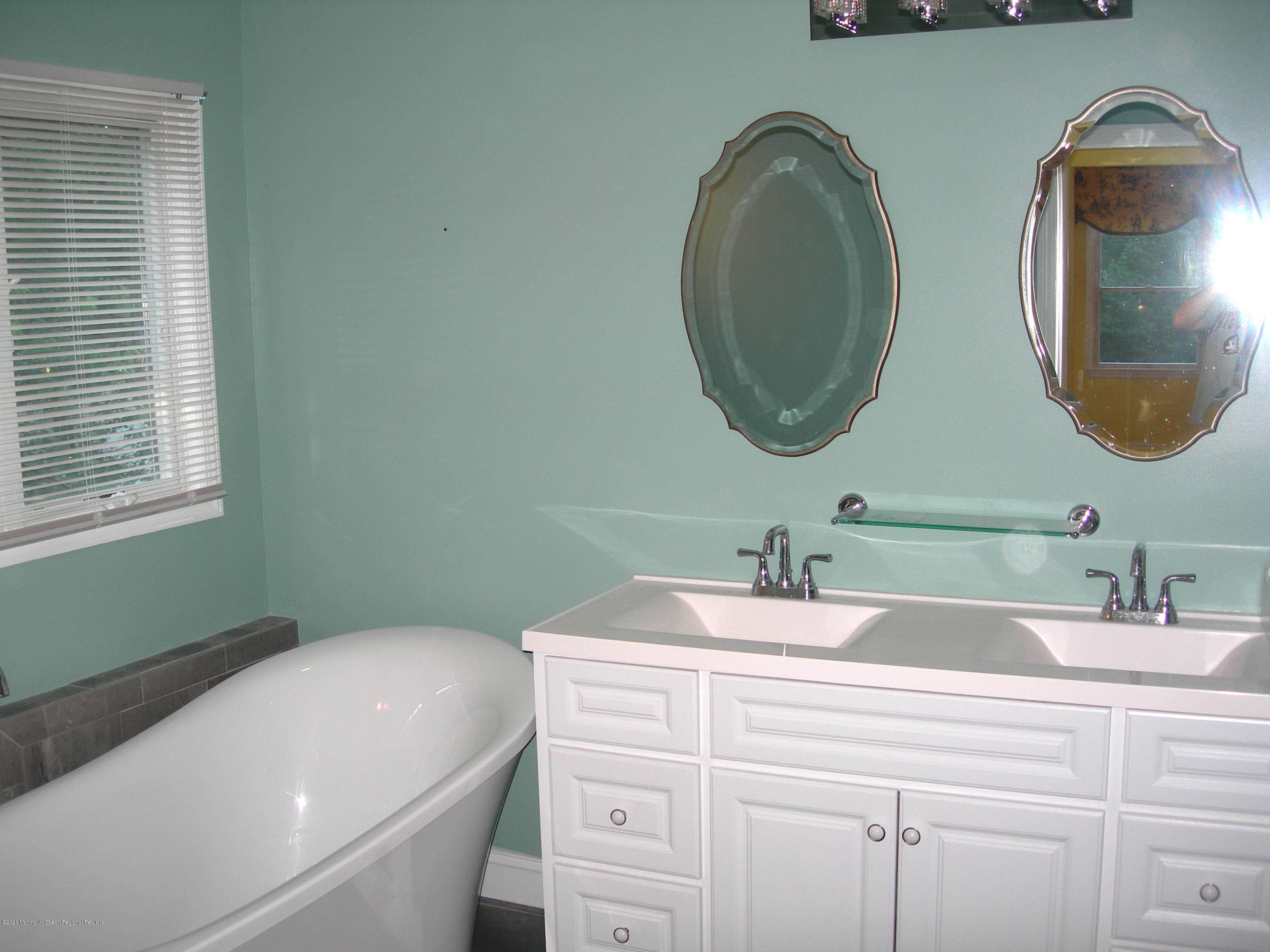 34 Shelbern Drive Lincroft, NJ 07738 - Photo 11 of 25 a bathroom with a sink and a mirror