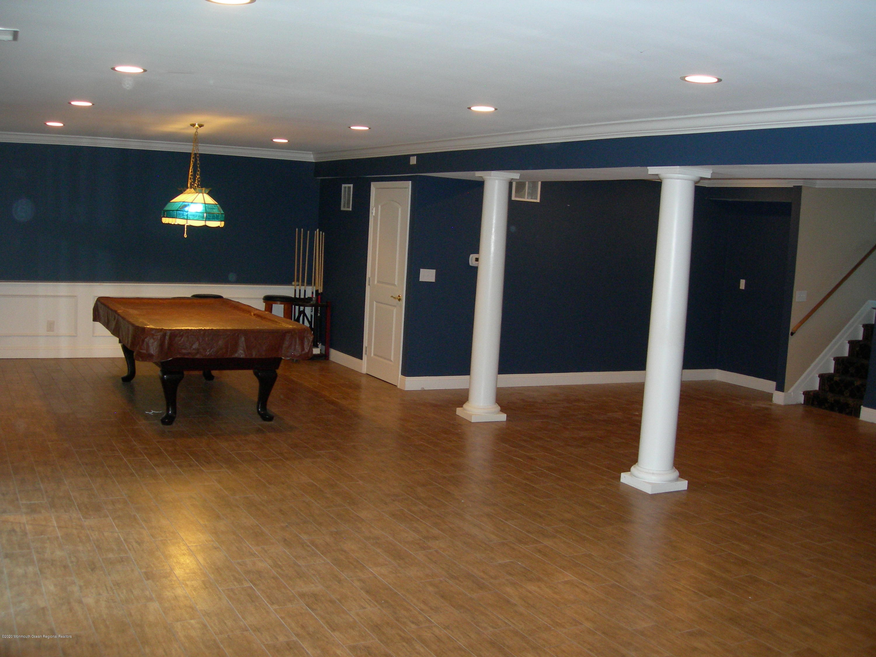 34 Shelbern Drive Lincroft, NJ 07738 - Photo 19 of 25 an empty room with wooden floor and windows