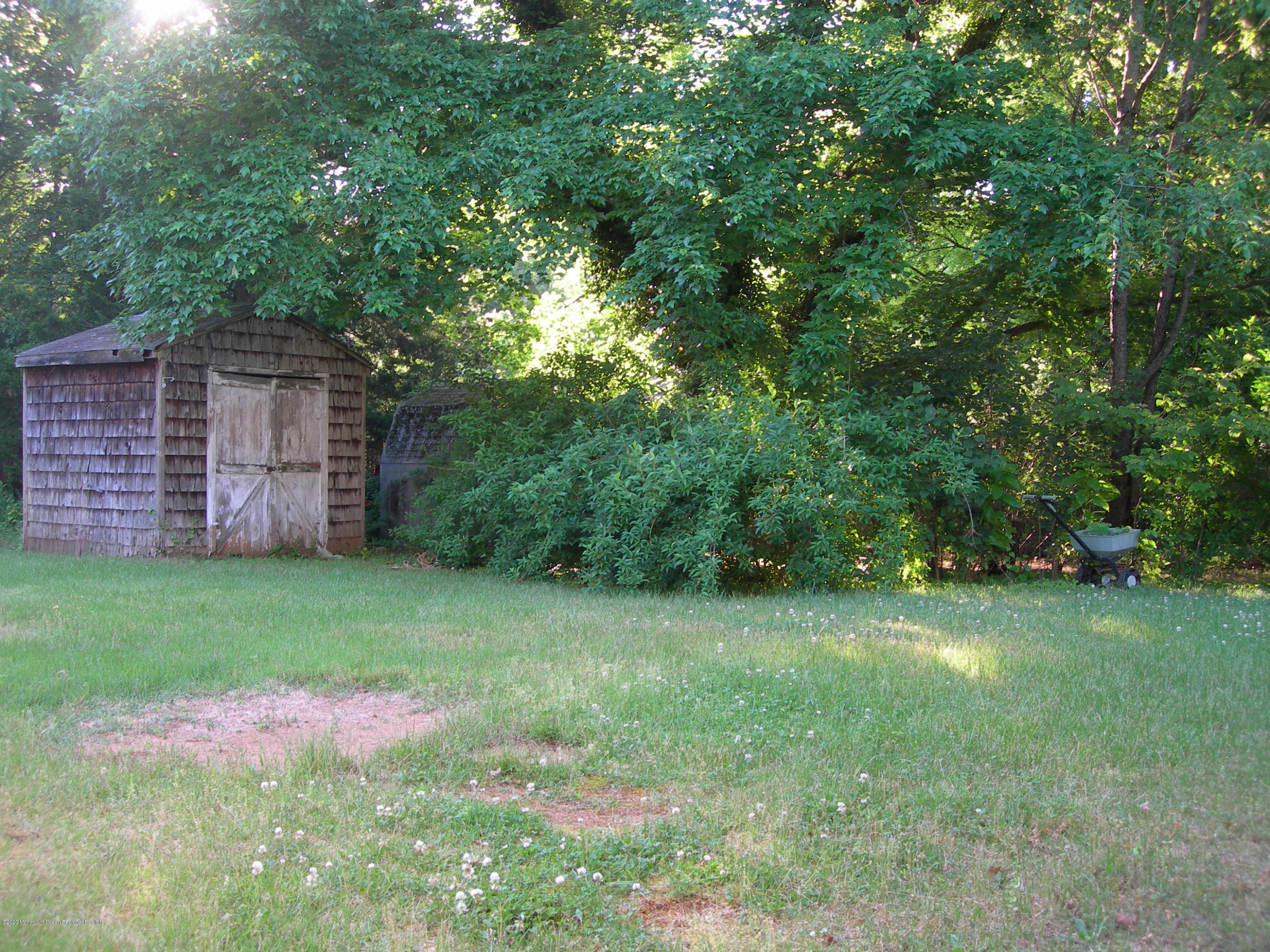 34 Shelbern Drive Lincroft, NJ 07738 - Photo 20 of 25 a view of a backyard with a garden