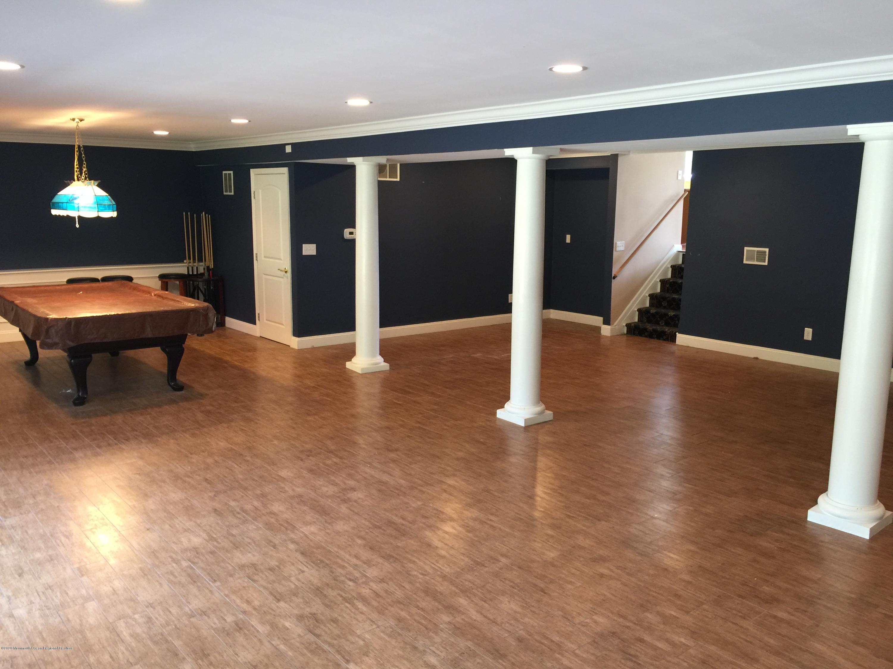 34 Shelbern Drive Lincroft, NJ 07738 - Photo 2 of 25 an empty room with wooden floor and windows
