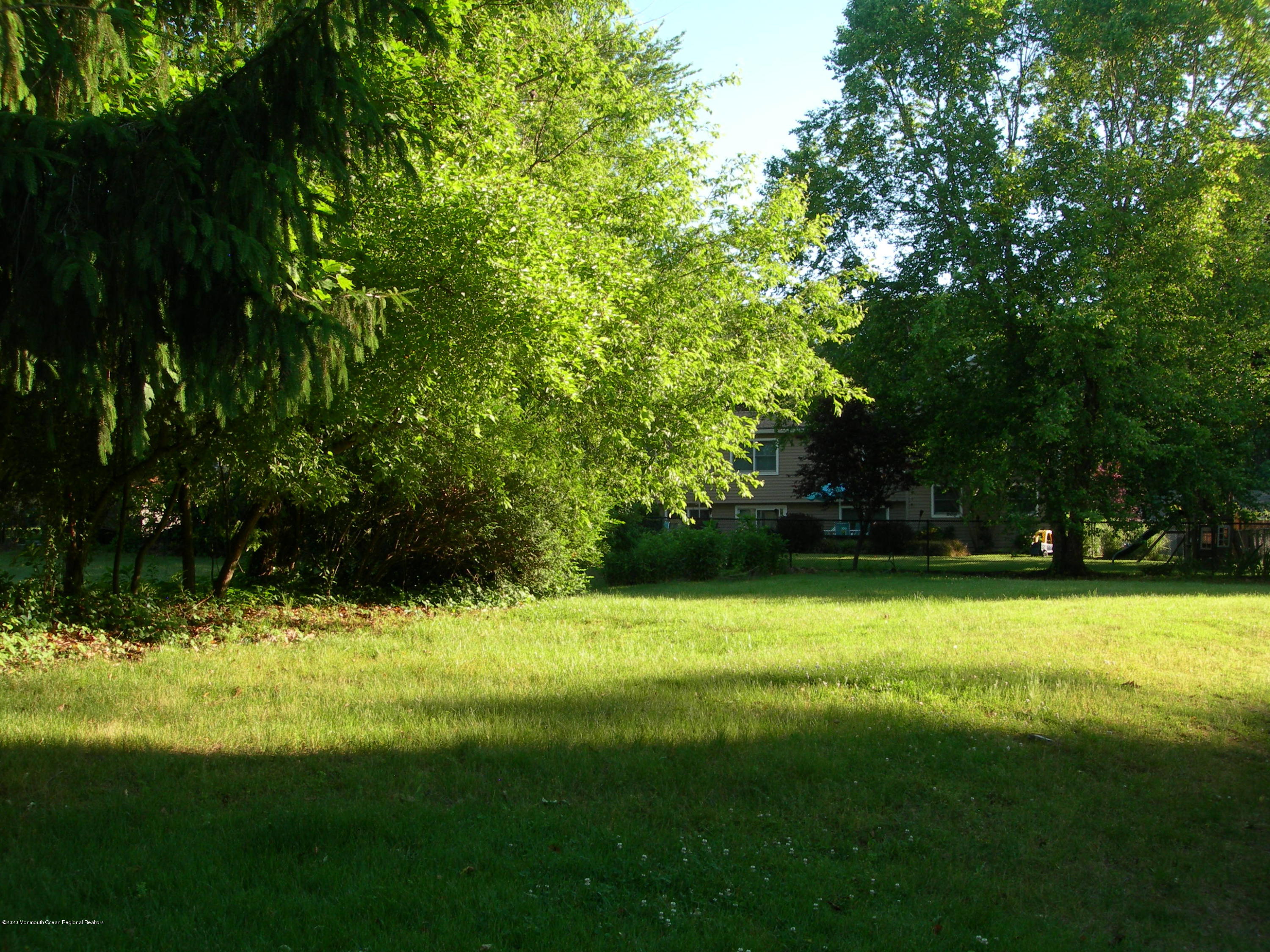 34 Shelbern Drive Lincroft, NJ 07738 - Photo 22 of 25 a view of a yard with a trees