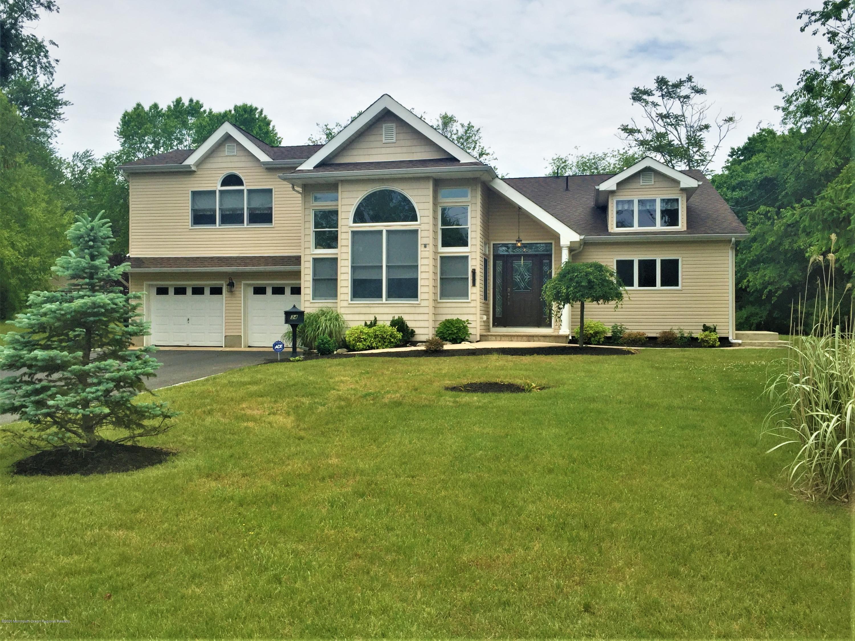 34 Shelbern Drive Lincroft, NJ 07738 - Photo 25 of 25 a front view of a house with a yard
