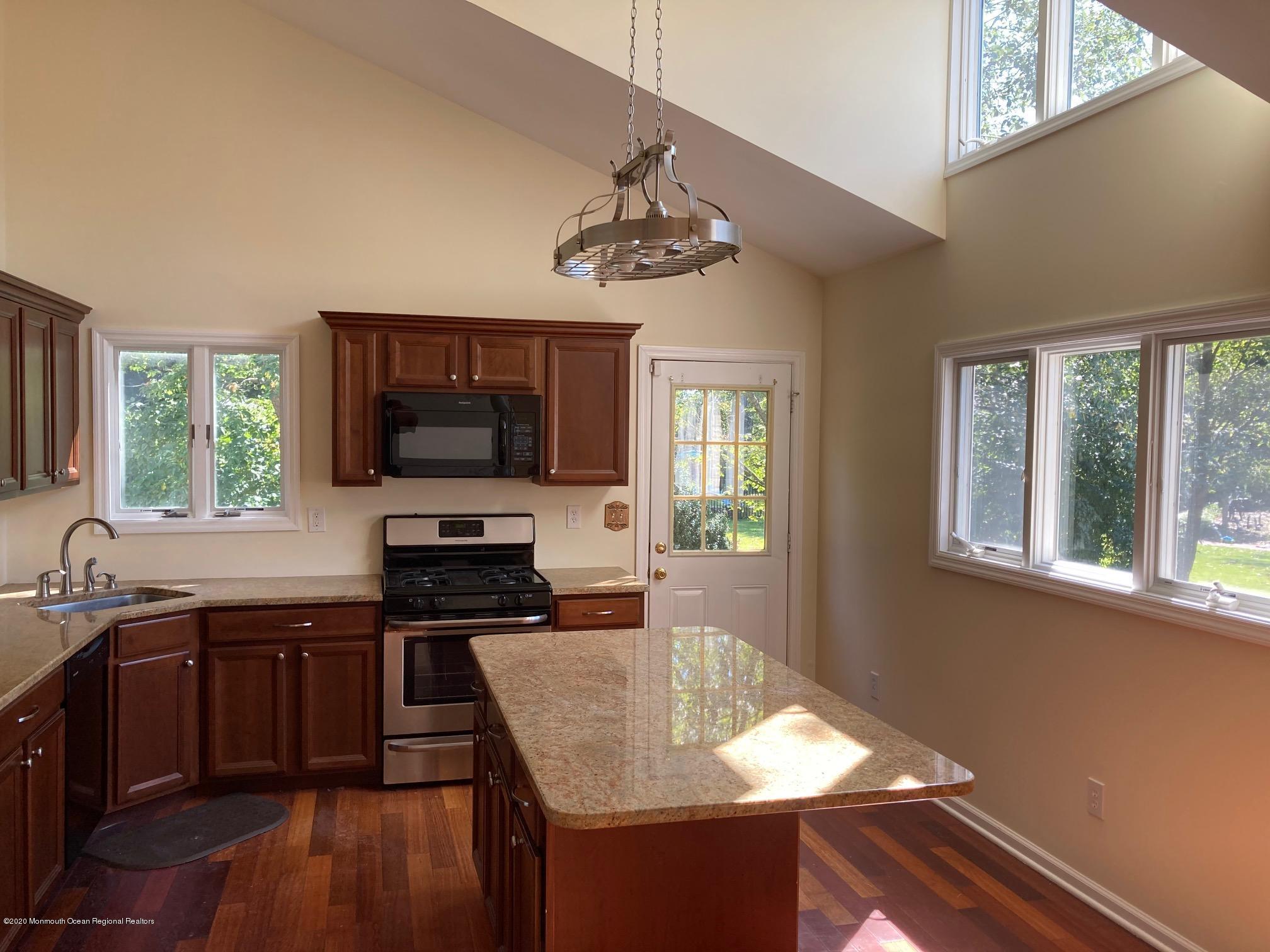34 Shelbern Drive Lincroft, NJ 07738 - Photo 4 of 25 a kitchen with a stove a sink and a microwave