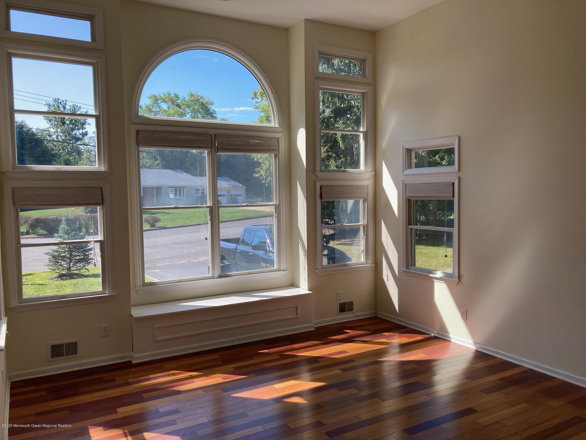 34 Shelbern Drive Lincroft, NJ 07738 - Photo 5 of 25 a view of an empty room with a window and wooden floor