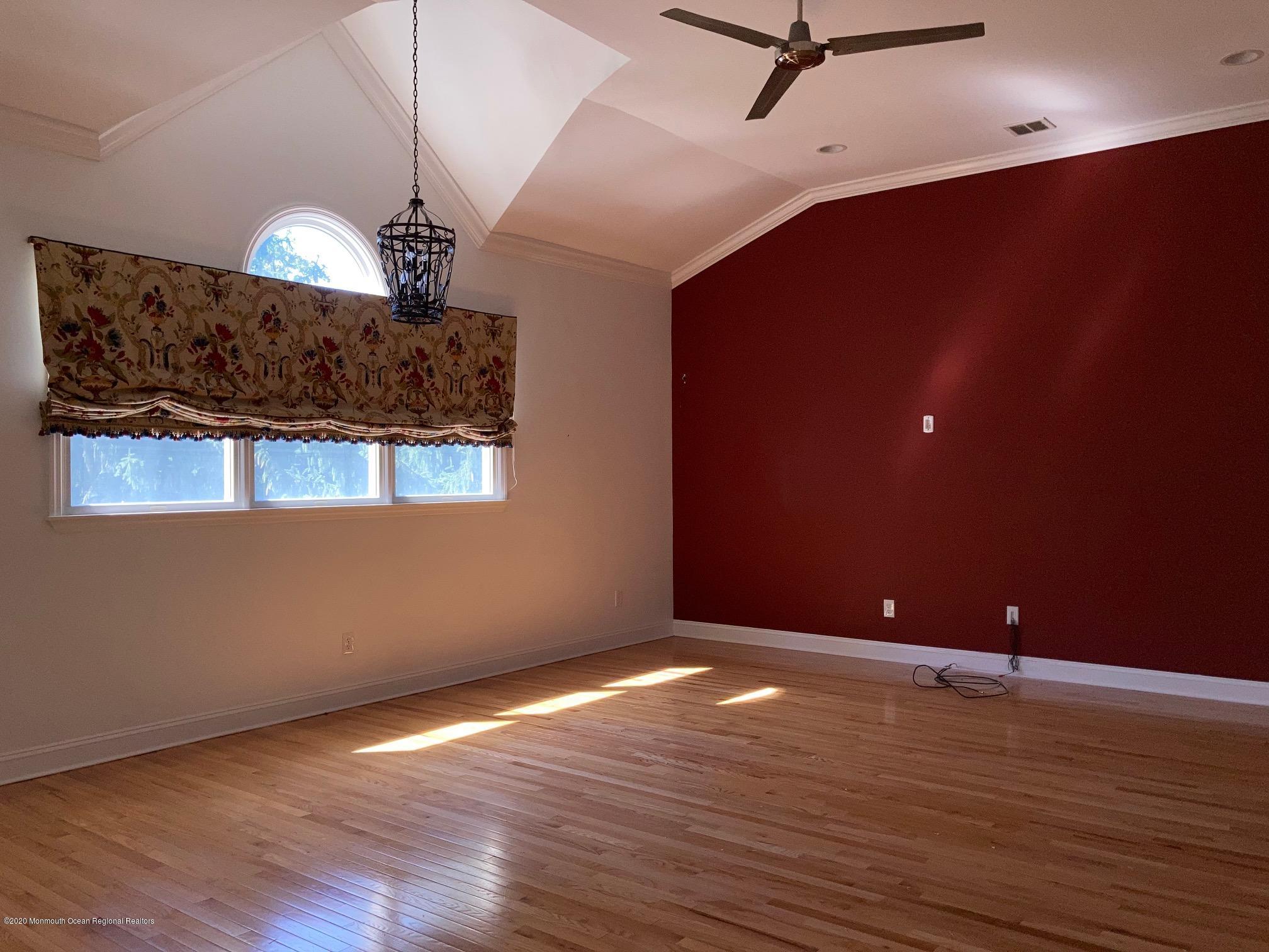 34 Shelbern Drive Lincroft, NJ 07738 - Photo 6 of 25 a view of a room with a ceiling fan and wooden floor