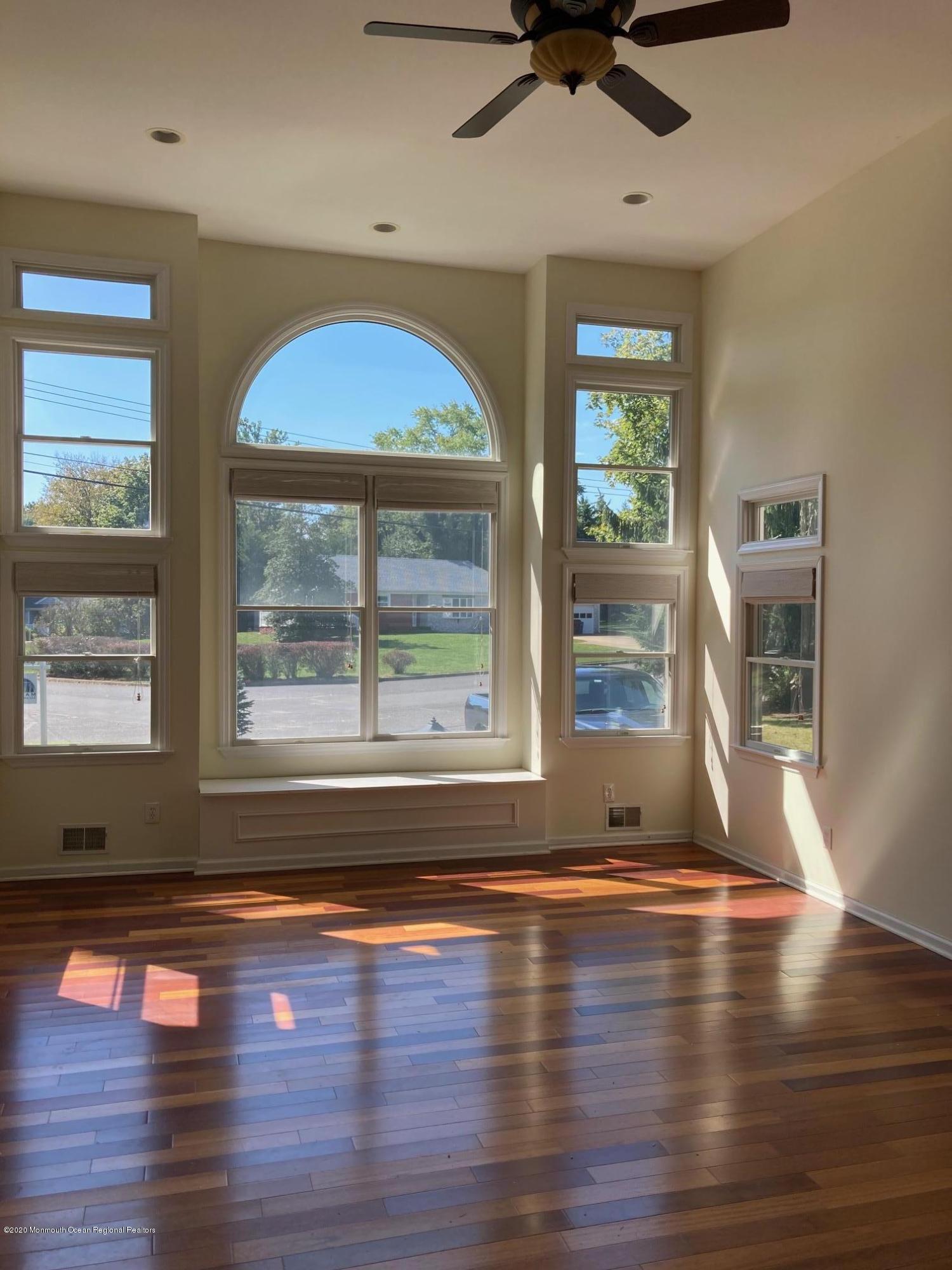 34 Shelbern Drive Lincroft, NJ 07738 - Photo 8 of 25 a view of empty room with wooden floor and fan