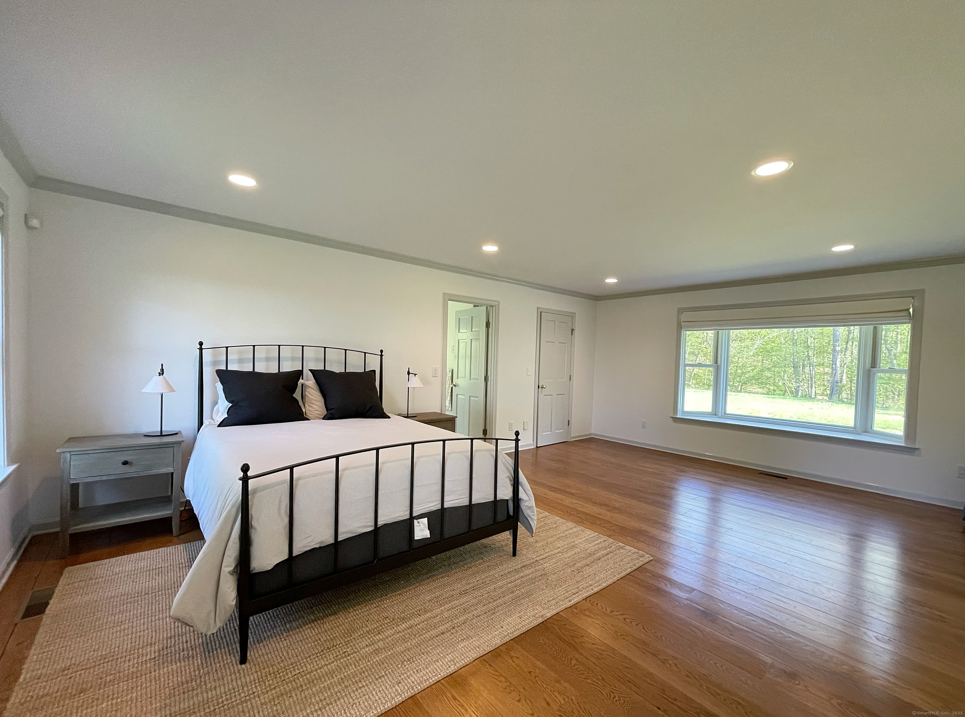 170 Rabbit Hill Road Warren, CT 06777 - Photo 18 of 28 a large bedroom with a bed and wooden floor