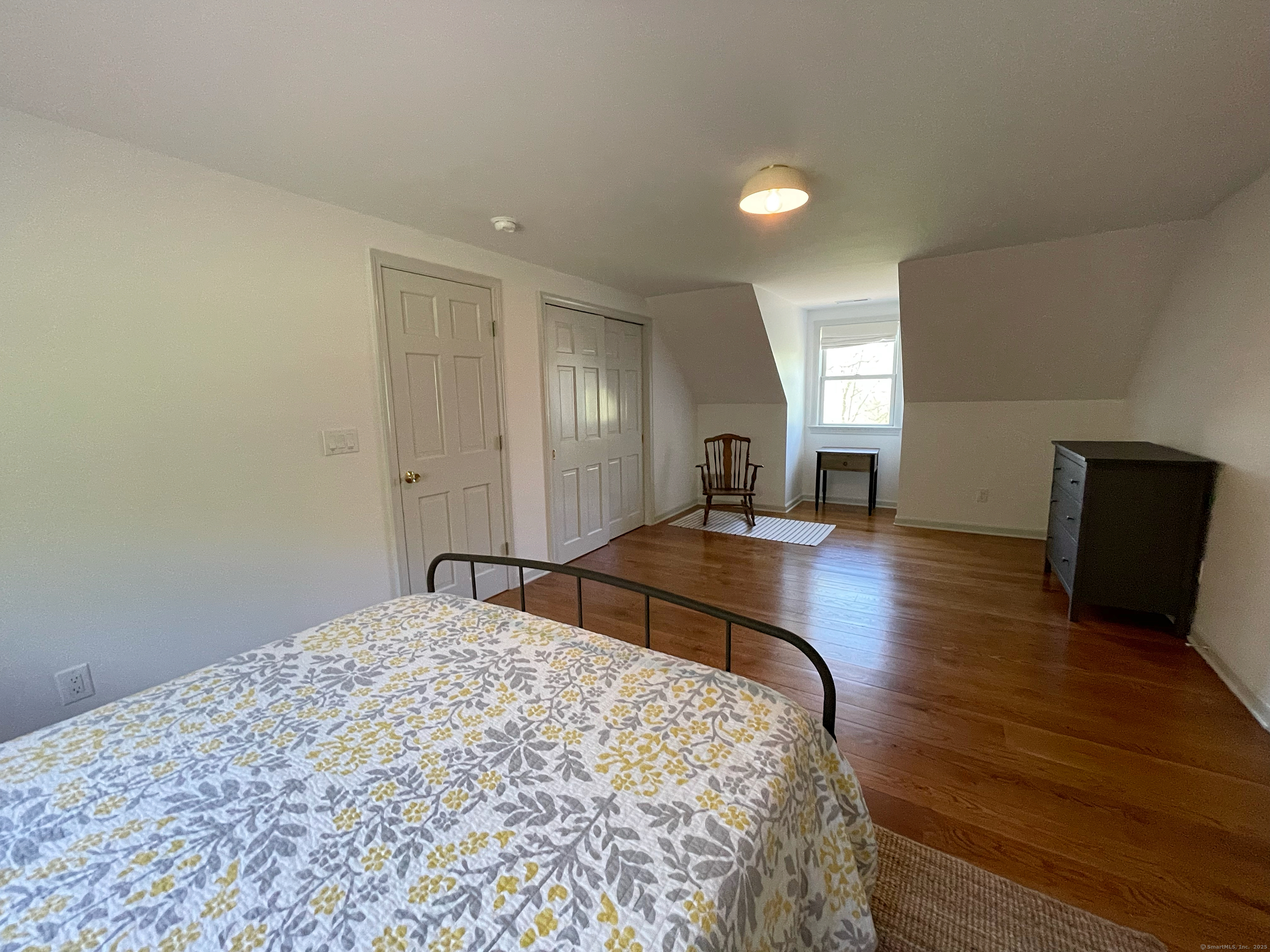 170 Rabbit Hill Road Warren, CT 06777 - Photo 25 of 28 a bedroom with a bed and wooden floor