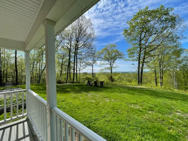a view of a balcony with furniture and garden