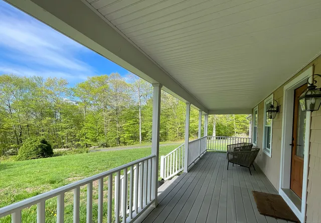 a view of a porch with wooden floor and outdoor space