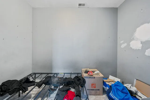 a kitchen with stainless steel appliances a refrigerator stove and wooden floor