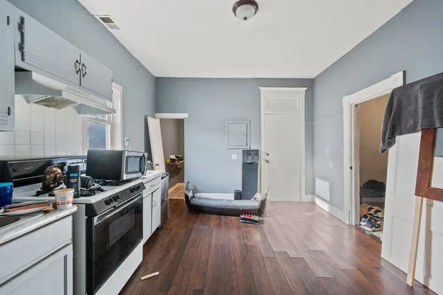 a bathroom with a sink a toilet and shower curtain