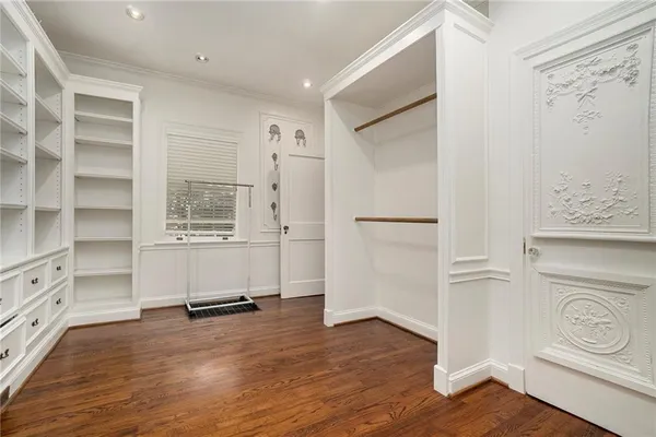 a view of a kitchen with wooden floor and cabinets