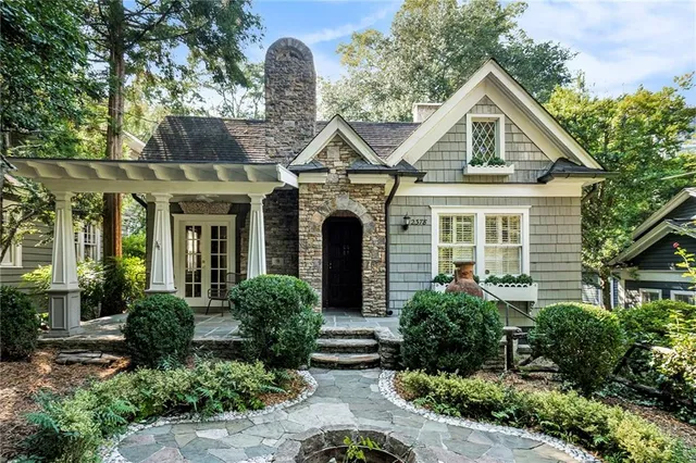 a view of backyard with plants and outdoor seating