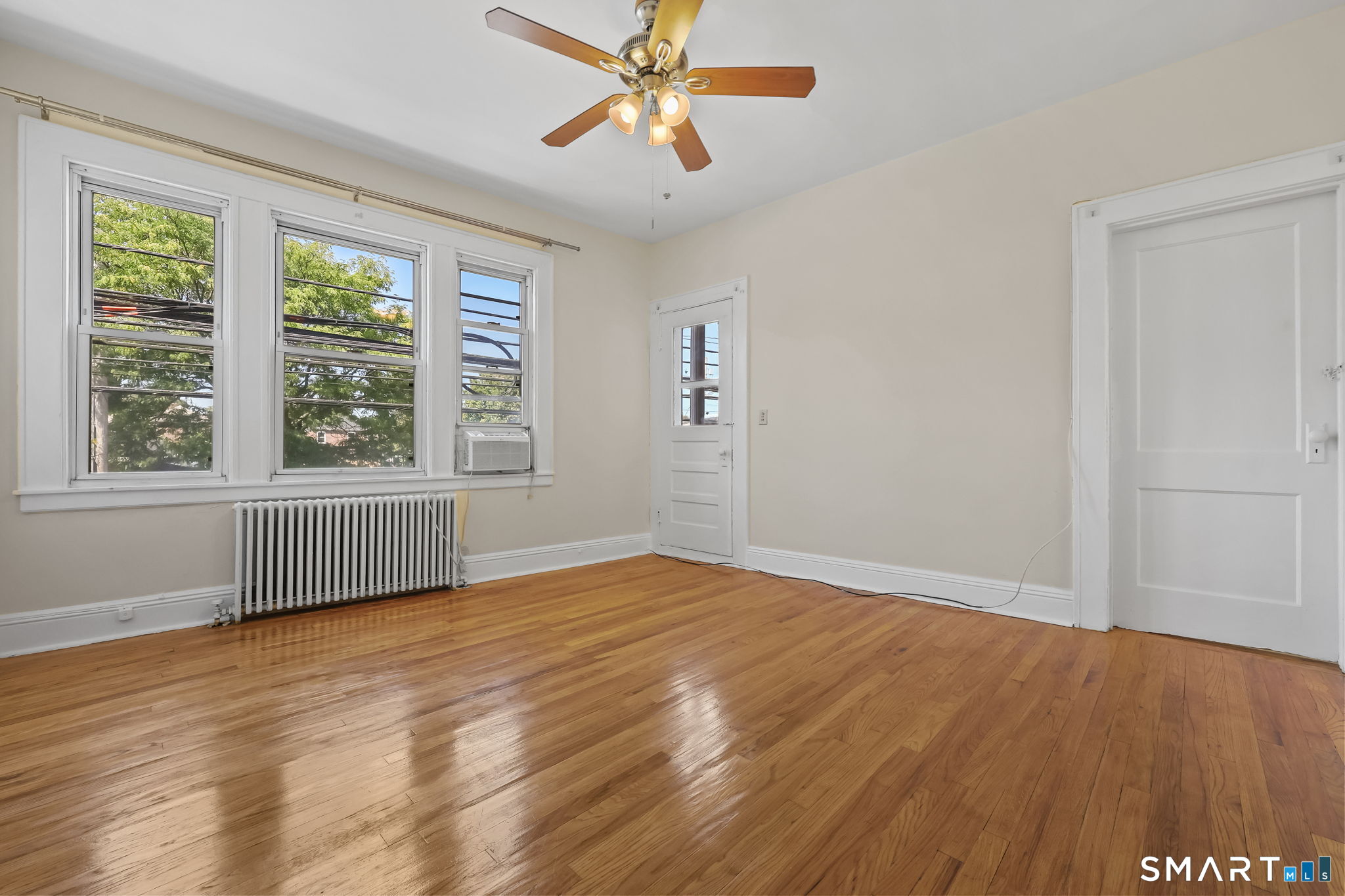 109 Post Road, Unit A Fairfield, CT 06824 - Photo 10 of 13 Living Room with Balcony Access