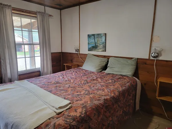 a bedroom with a large bed and a window