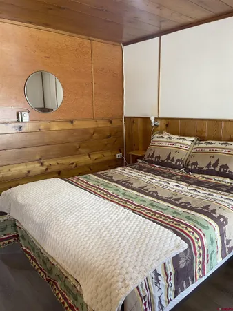 a bedroom with a bed and lamp