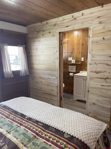 a bedroom with a bed and cabinets