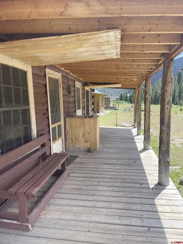 a view of a balcony with wooden floor and outdoor space