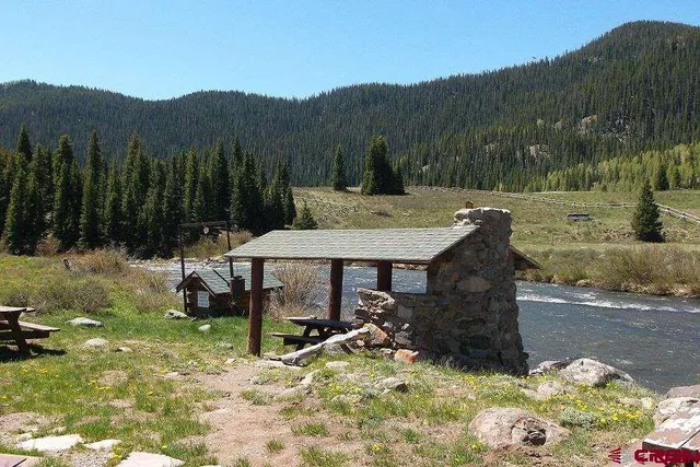 a view of a house with a yard and sitting area