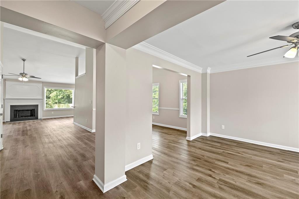 6020 Aderhold Way Alpharetta, GA 30004 - Photo 2 of 16 an empty room with wooden floor fireplace and windows
