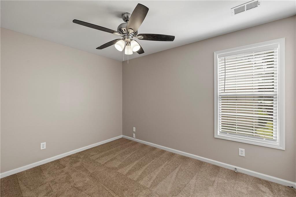 6020 Aderhold Way Alpharetta, GA 30004 - Photo 8 of 16 an empty room with a window and a fan