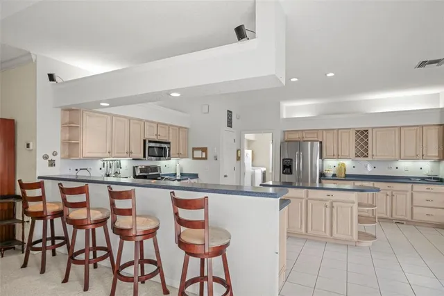 a kitchen with granite countertop white cabinets and stainless steel appliances