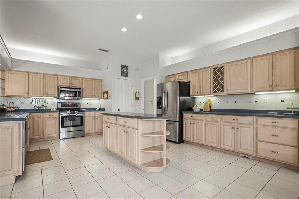 4503 North Rye Road Parrish, FL 34219 - Photo 16 of 68 a kitchen with granite countertop cabinets and stainless steel appliances
