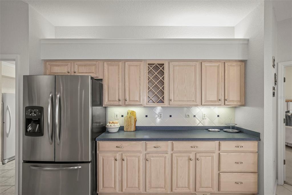 4503 North Rye Road Parrish, FL 34219 - Photo 17 of 68 a kitchen with granite countertop a refrigerator a sink and cabinets