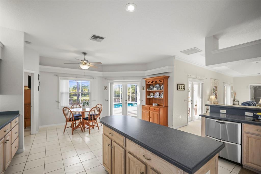 4503 North Rye Road Parrish, FL 34219 - Photo 20 of 68 a kitchen with stainless steel appliances granite countertop a stove top oven a sink a dining table and chairs