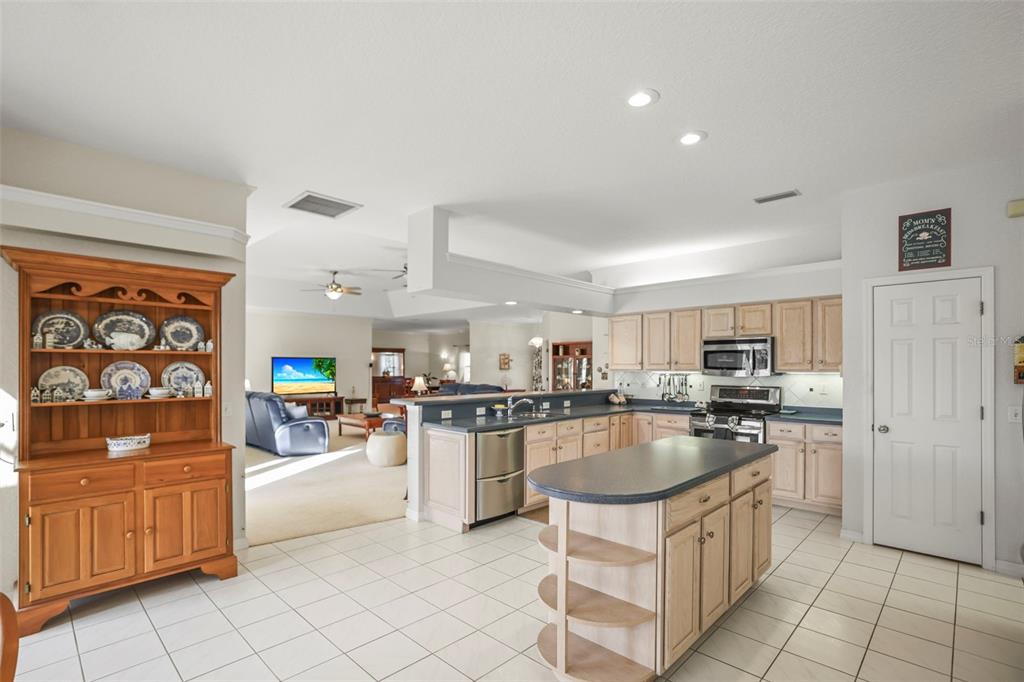 4503 North Rye Road Parrish, FL 34219 - Photo 21 of 68 a kitchen with stainless steel appliances granite countertop a stove top oven a sink dishwasher and cabinets with wooden floor