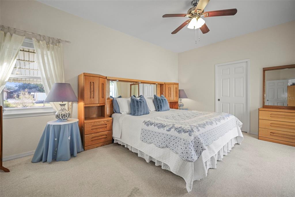 4503 North Rye Road Parrish, FL 34219 - Photo 23 of 68 a spacious bedroom with a bed and a chandelier