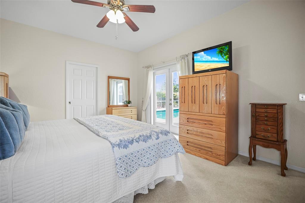 4503 North Rye Road Parrish, FL 34219 - Photo 24 of 68 a bedroom with a bed and a chandelier