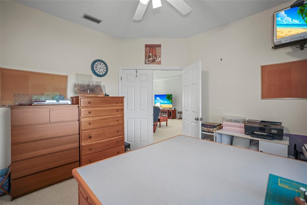 4503 North Rye Road Parrish, FL 34219 - Photo 32 of 68 a bedroom with a bed and a chandelier