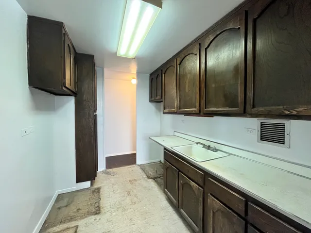 a kitchen with stainless steel appliances granite countertop a sink and a microwave