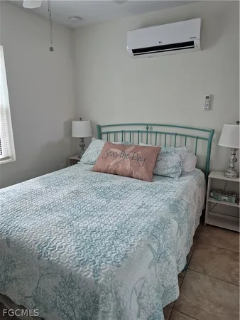 a large bed in a bedroom next to a window