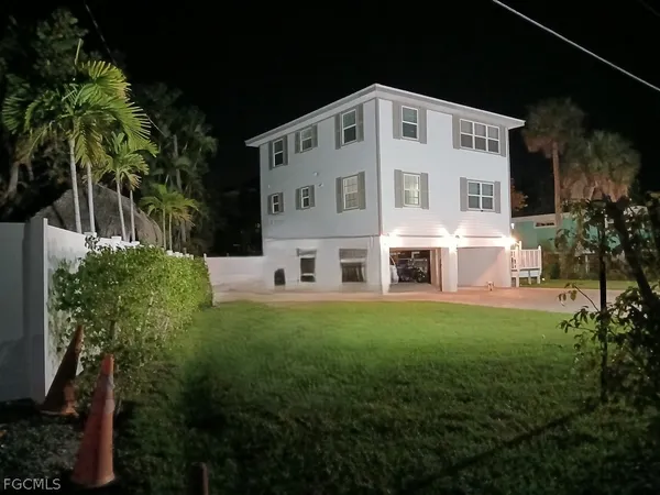 a front view of a house with a garden