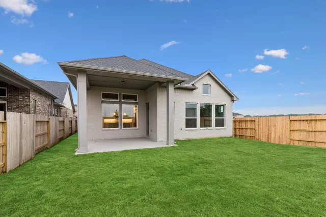a view of a house with a yard and porch