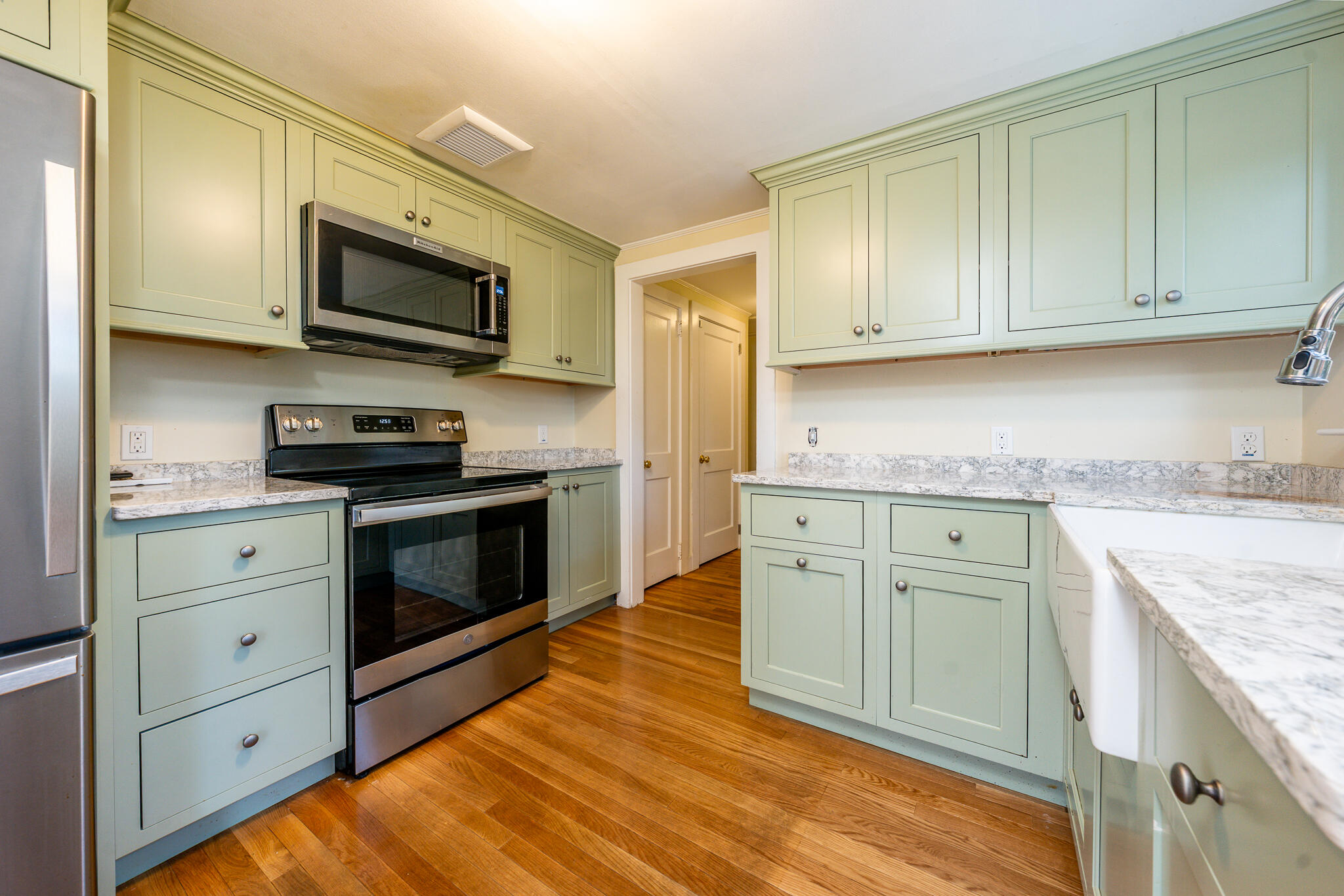 54 Murphy Road Hyannis, MA 02601 - Photo 17 of 30 a kitchen with granite countertop cabinets stainless steel appliances and wooden floor