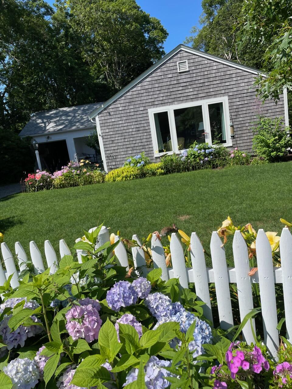 54 Murphy Road Hyannis, MA 02601 - Photo 3 of 30 a front view of a house with a yard and outdoor seating