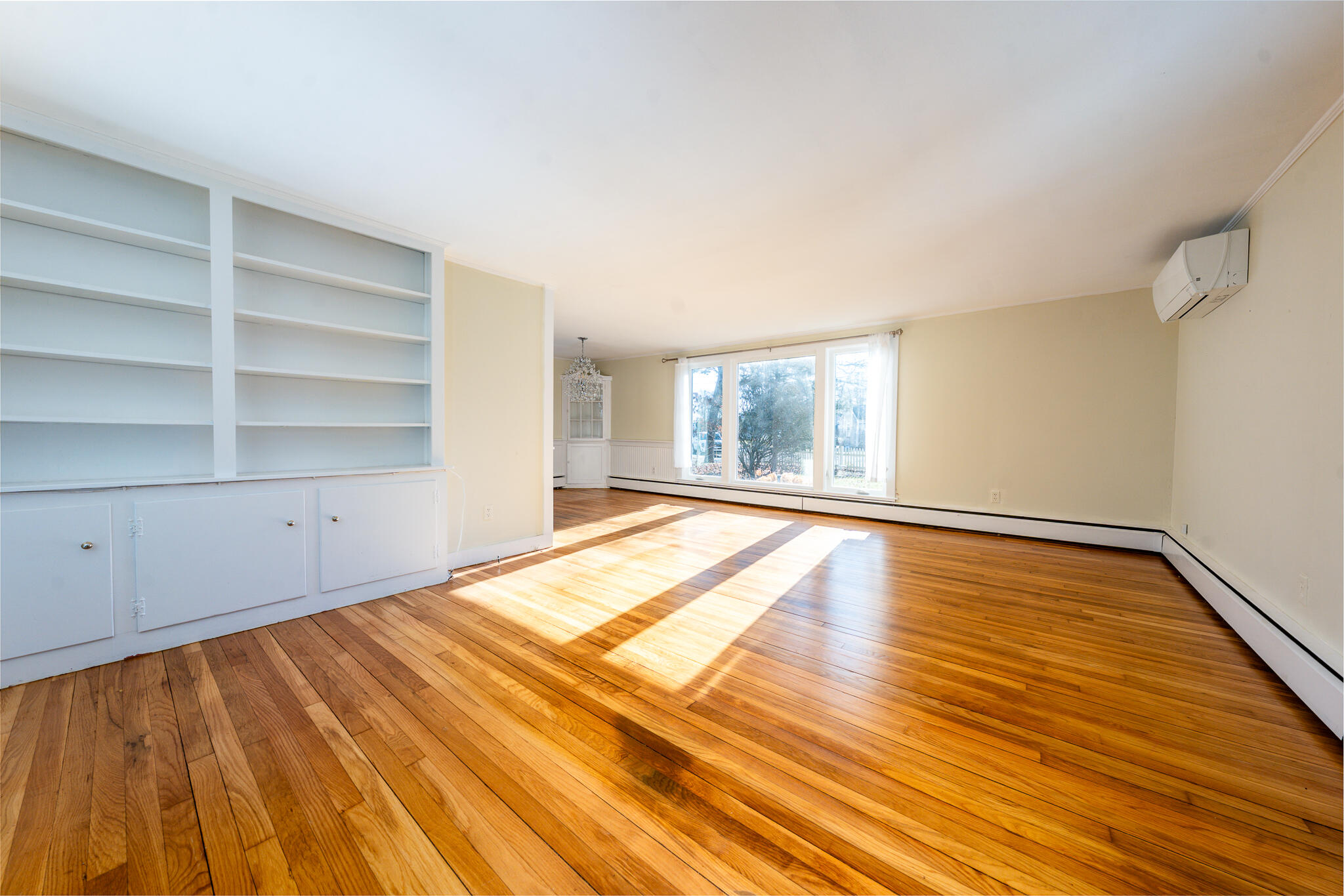 54 Murphy Road Hyannis, MA 02601 - Photo 9 of 30 a view of an empty room with wooden floor and a window
