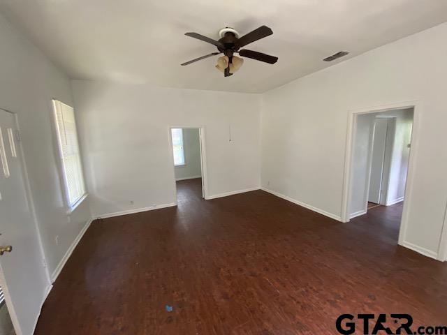 306 South Fenton Avenue Tyler, TX 75702 - Photo 2 of 11 an empty room with wooden floor and windows