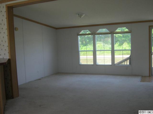 145 Potter's Road Woodleaf, NC 27054 - Photo 3 of 5 an empty room with a window