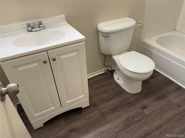 a white toilet sitting next to a bathroom sink