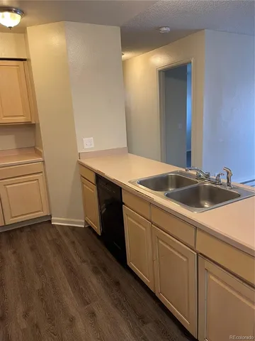 a kitchen with stainless steel appliances granite countertop a sink and a refrigerator
