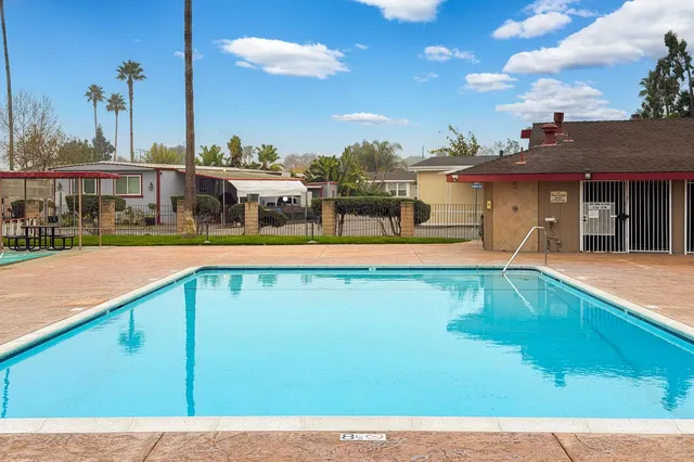 a view of a swimming pool with lawn chairs