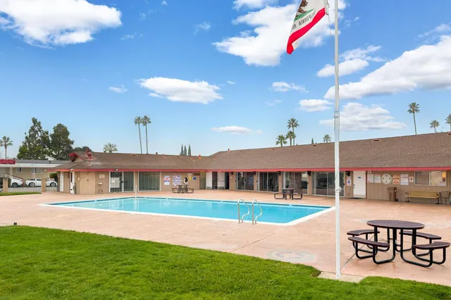 a view of a house with swimming pool yard and sitting area