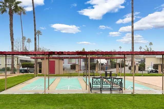a view of a house with a yard deck and a patio