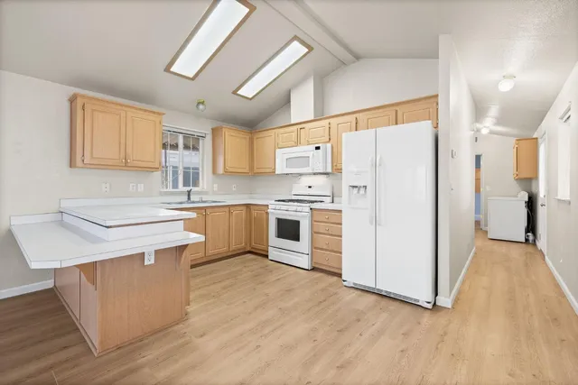 a kitchen with stainless steel appliances a stove a refrigerator and a sink