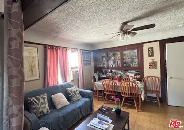 a kitchen with stainless steel appliances white cabinets and a sink a stove a refrigerator with wooden floors